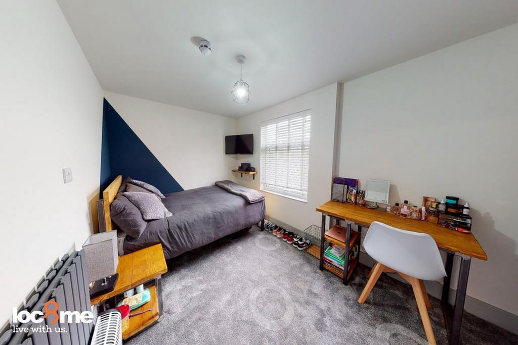 A stylish and well-maintained double bedroom, p...