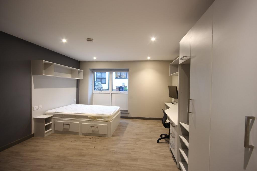 A bright and spacious double bedroom featuring ...