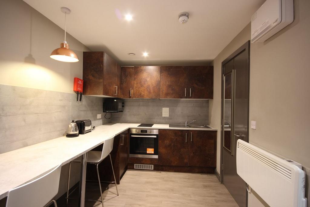 A modern kitchenette featuring stylish cabinetr...
