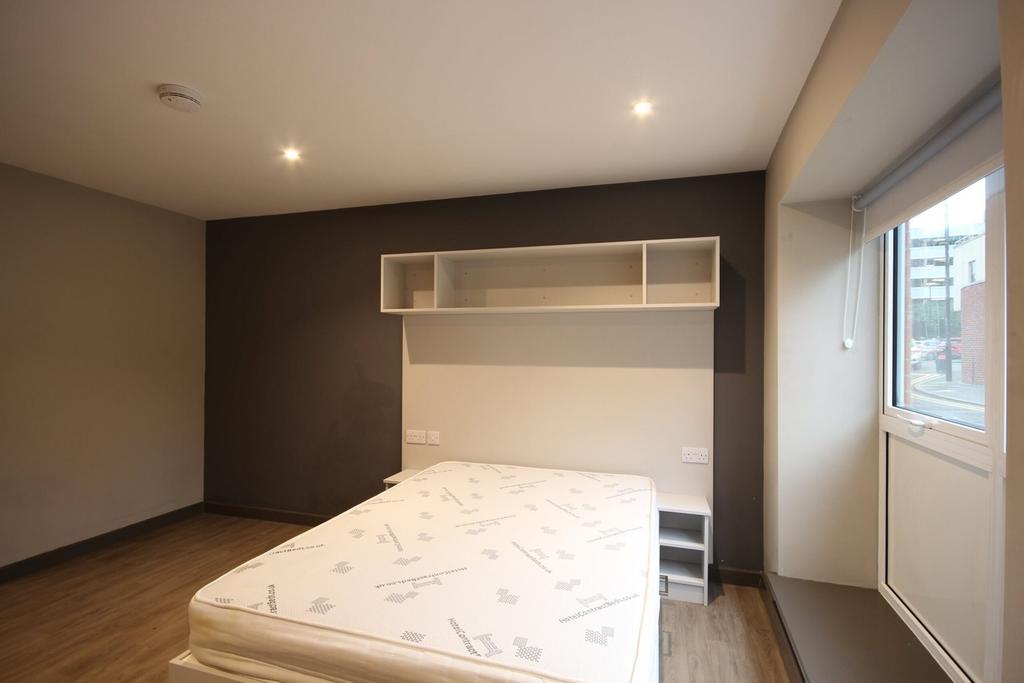 A spacious and bright double bedroom with moder...