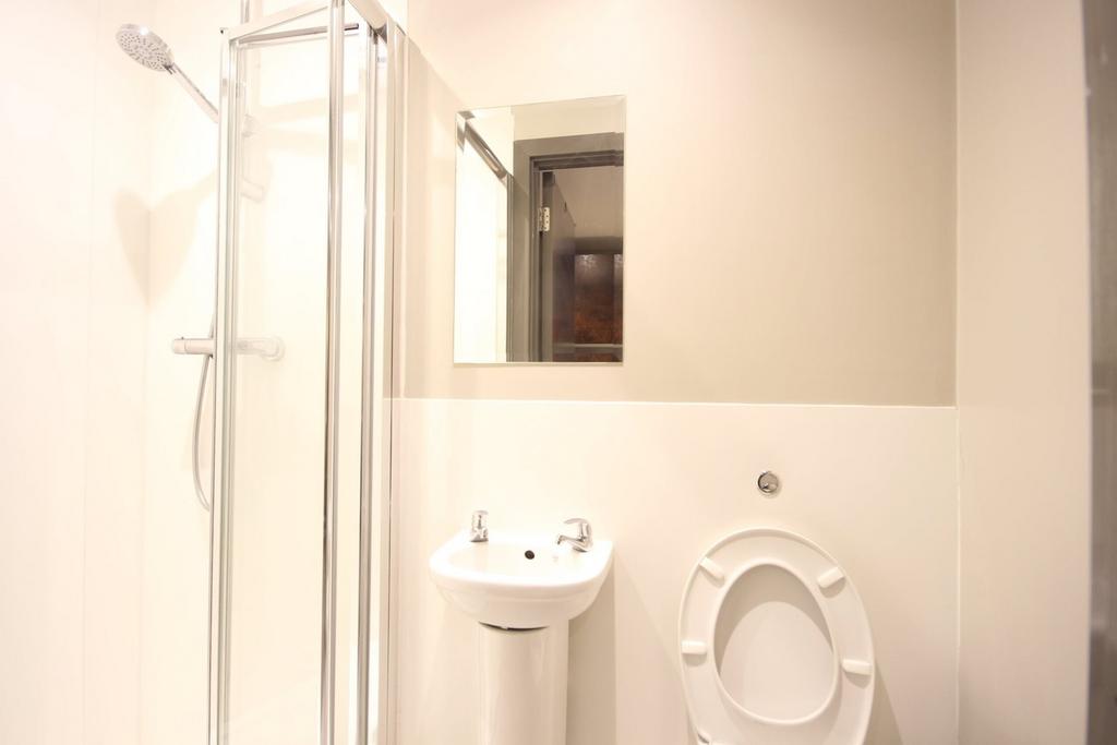 A modern and clean bathroom featuring a shower,...