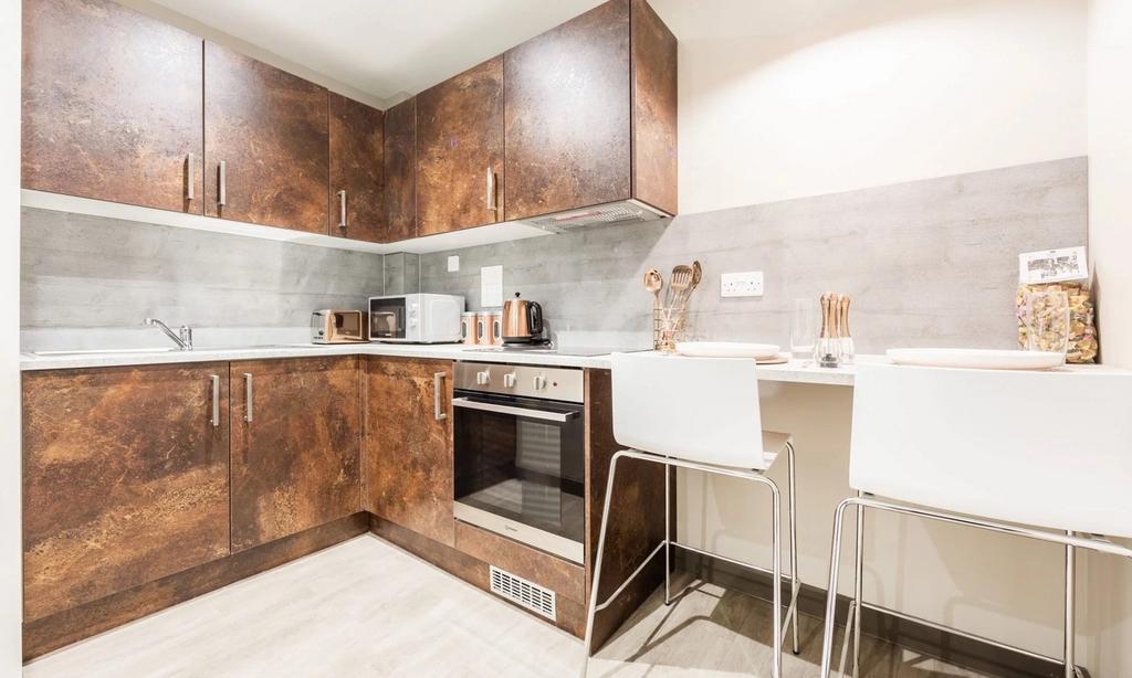 A modern and clean kitchenette with stylish cab...