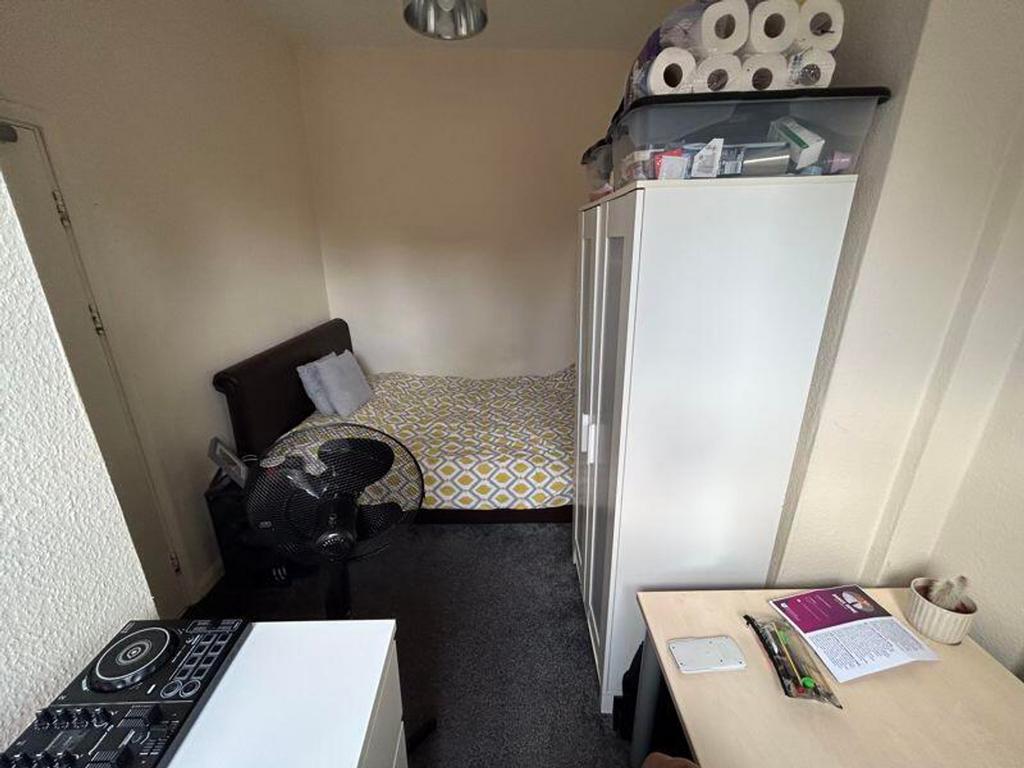 A cozy double bedroom with a comfortable bed an...