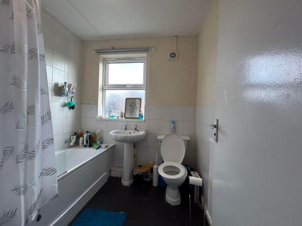 A functional and bright bathroom featuring a ba...