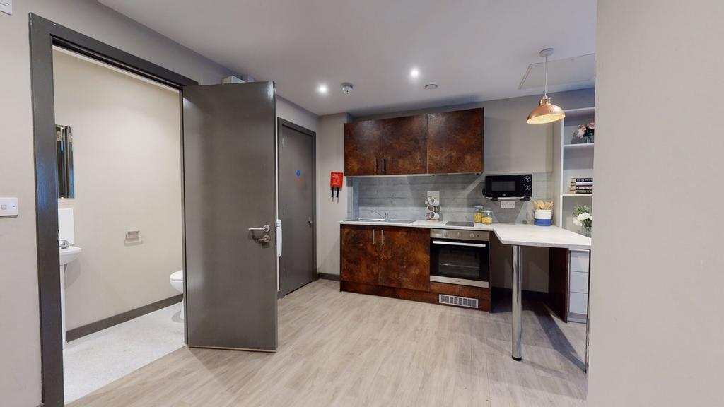 A modern and clean kitchenette with ample stora...