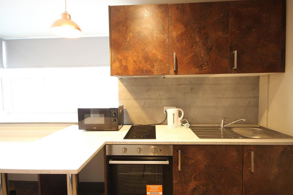 A modern and tidy kitchenette featuring sleek c...