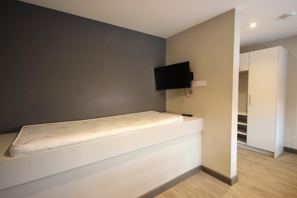 A modern and tidy double bedroom with ample spa...