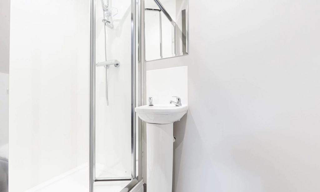 A sleek and modern bathroom featuring a spaciou...