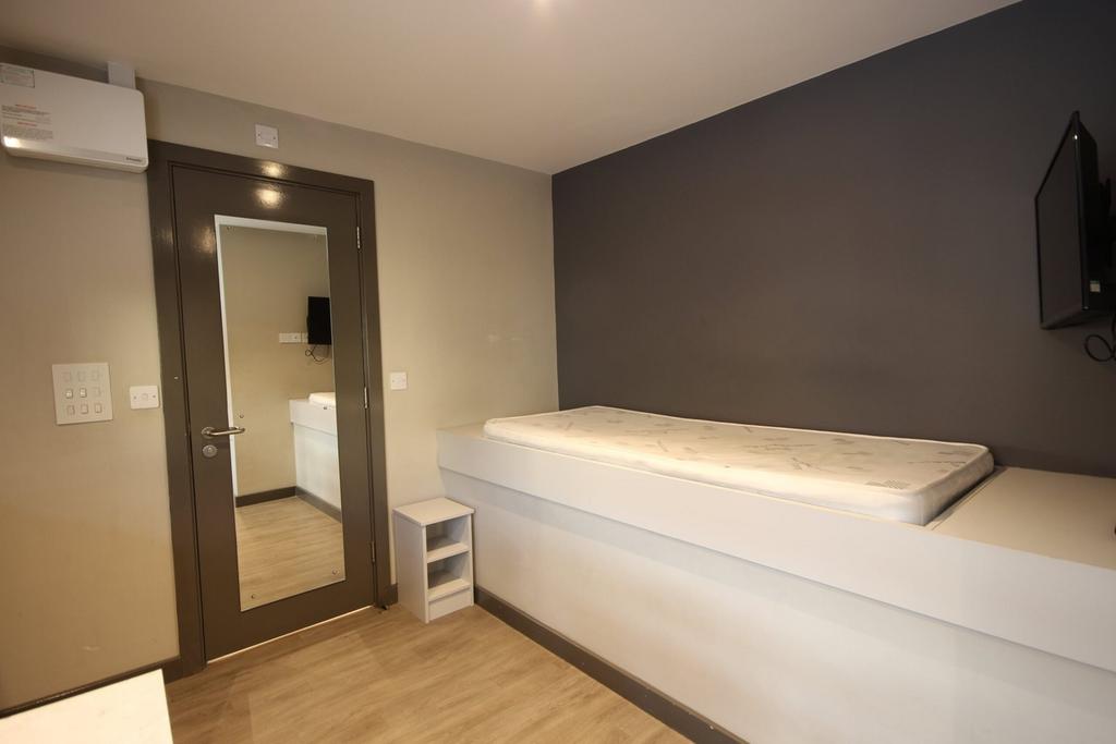 A spacious and modern double bedroom with a sle...
