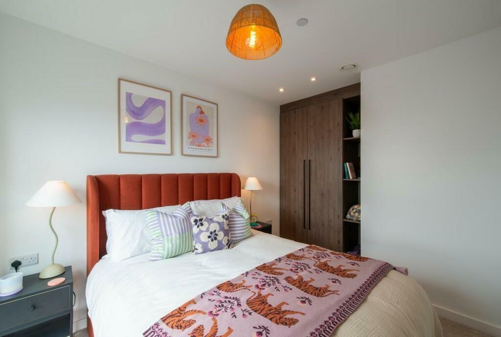 A cozy and well-decorated double bedroom featur...