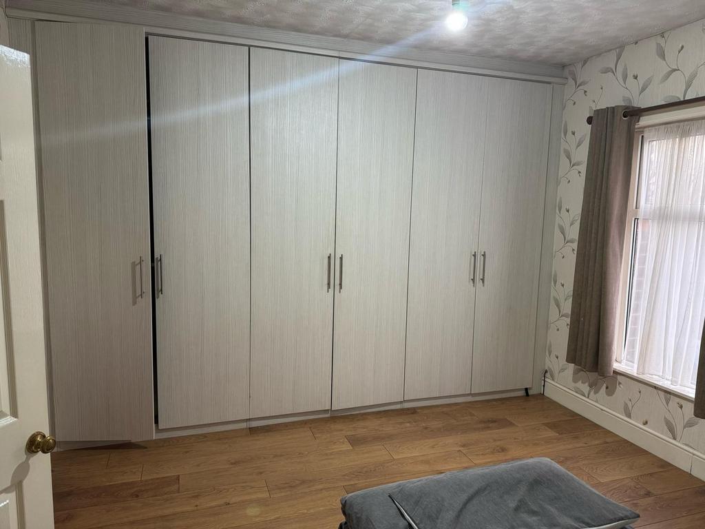 This inviting double bedroom features ample fit...
