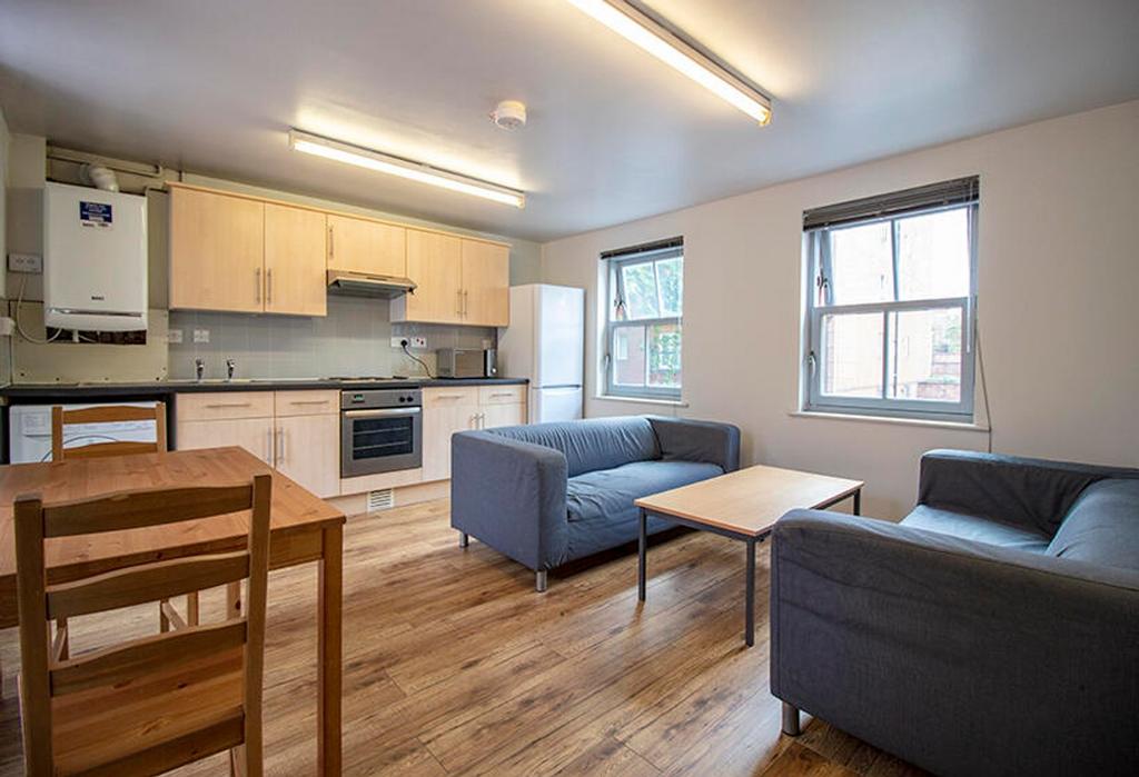 Spacious and modern living room featuring ample...