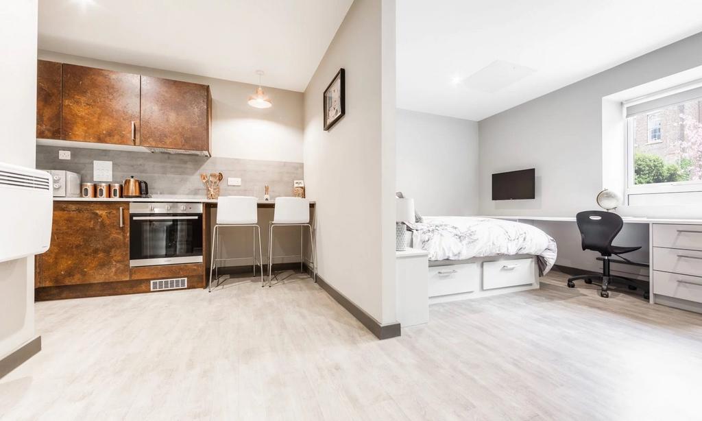 A spacious and modern living area featuring a w...