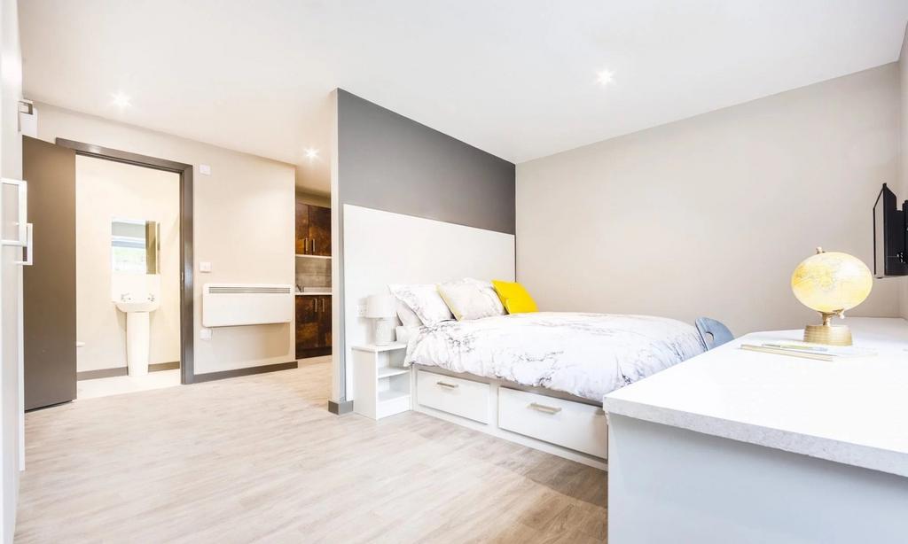 A bright and spacious double bedroom with moder...