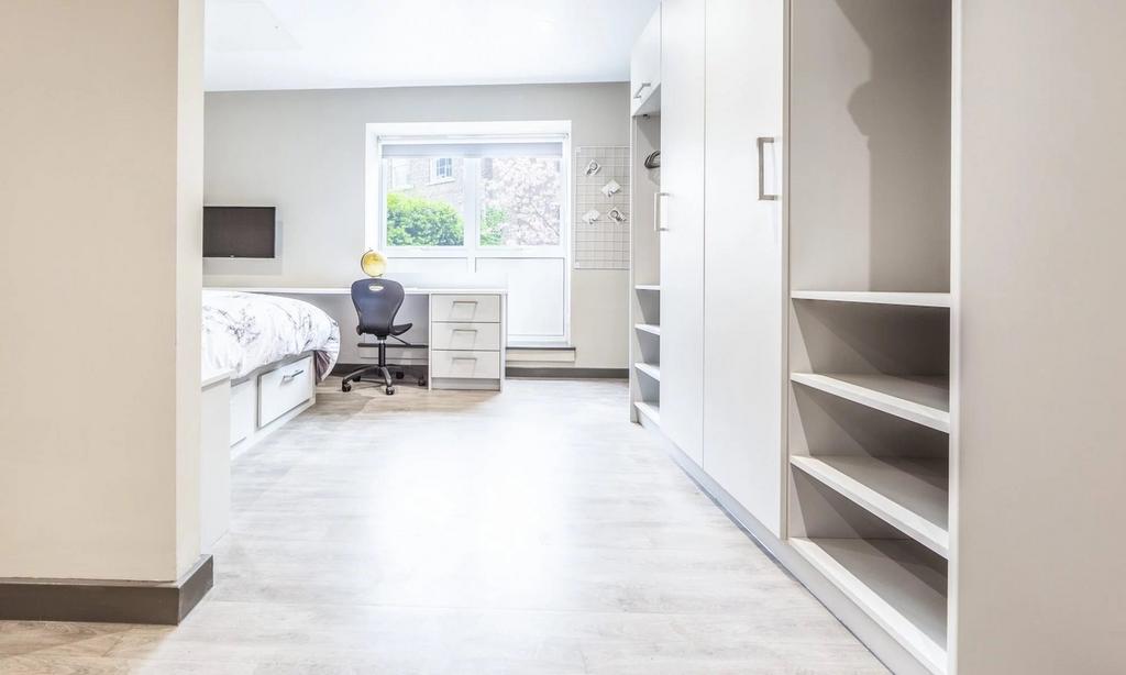 A spacious and modern double bedroom featuring ...