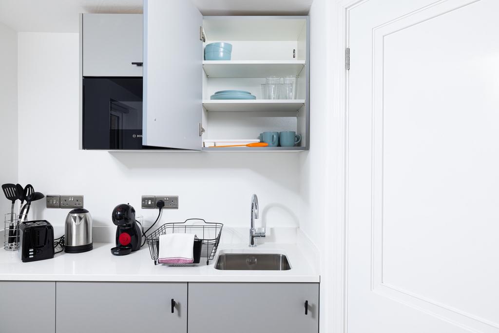 Modern kitchen equipped with sleek cabinetry an...