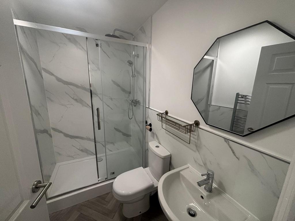 Stylish bathroom featuring a modern glass showe...