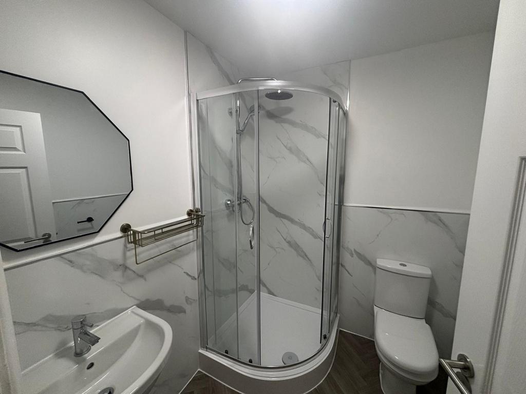 This modern bathroom features sleek marble acce...