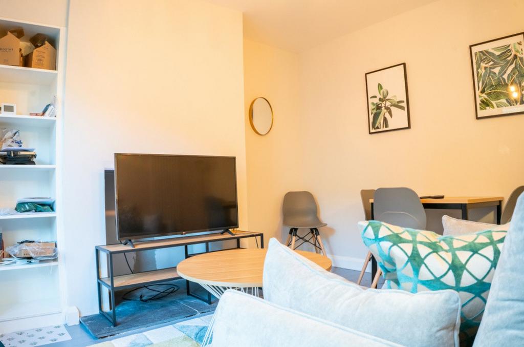 A cozy and inviting living room with ample natu...