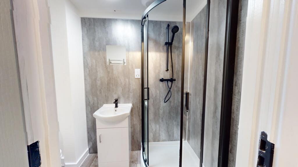 A modern and clean bathroom with a stylish show...