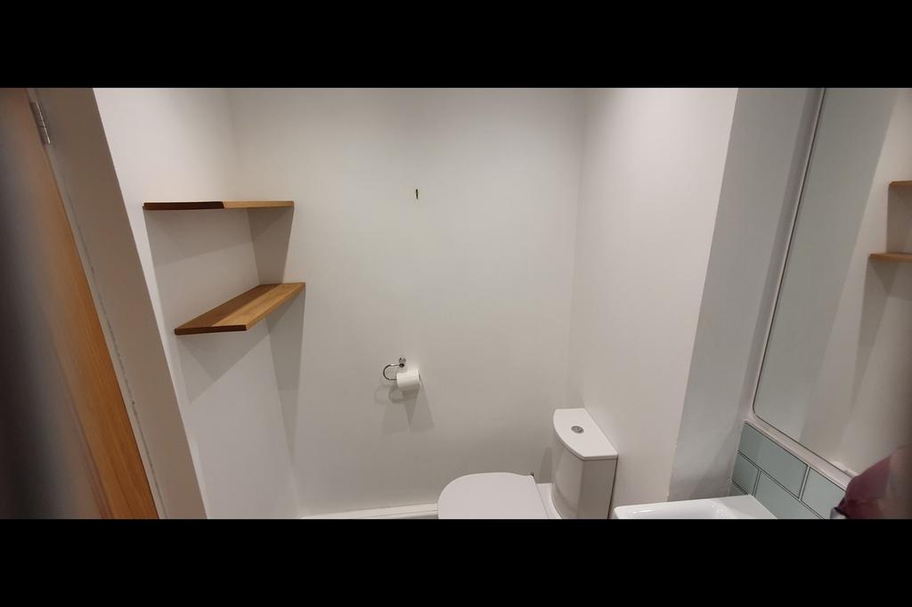 A modern bathroom featuring a clean design with...