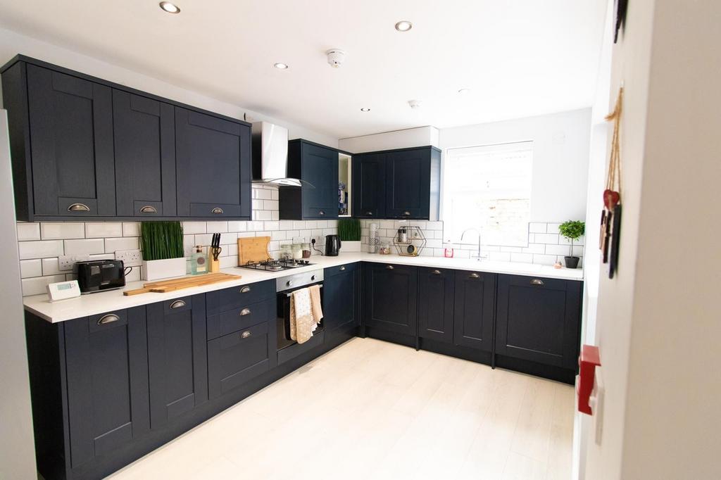 A modern and spacious kitchen featuring sleek n...