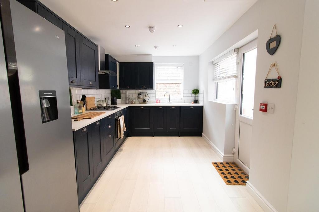 A bright and modern kitchen featuring sleek cab...