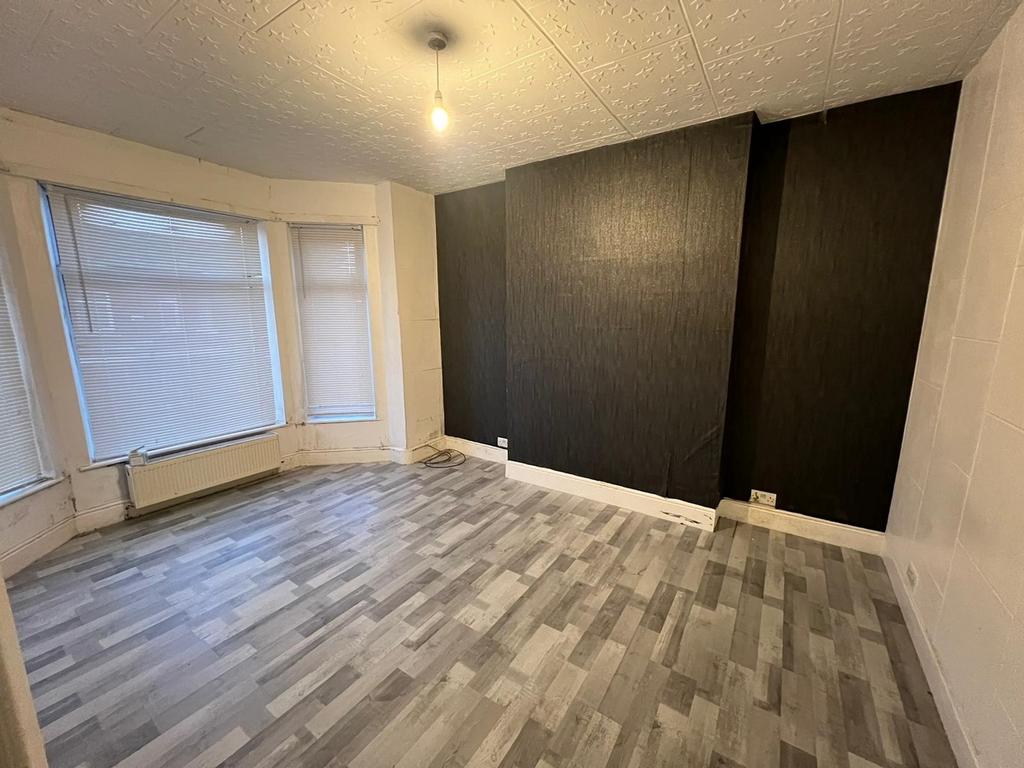 Spacious living room featuring large windows th...