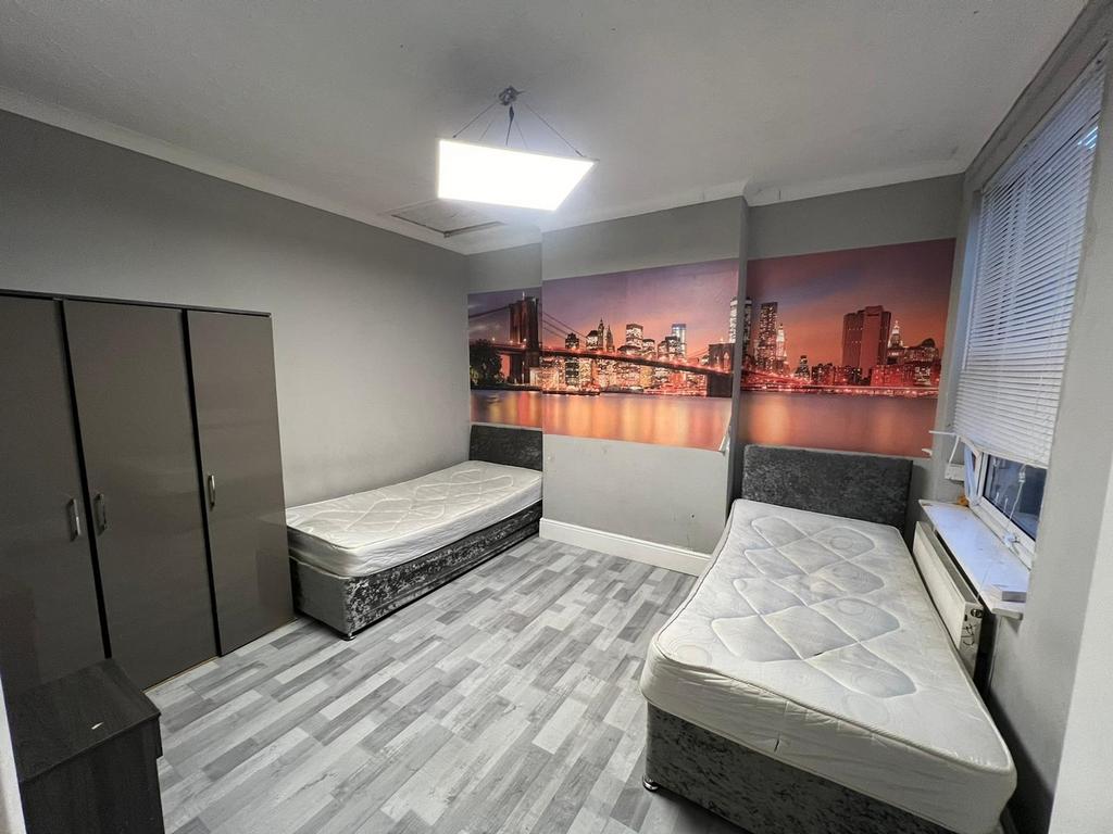 Spacious double bedroom featuring modern decor,...