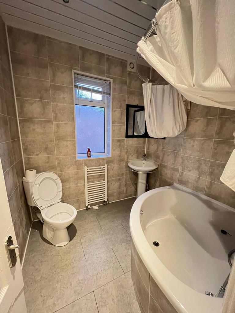 This well-appointed bathroom features a spaciou...