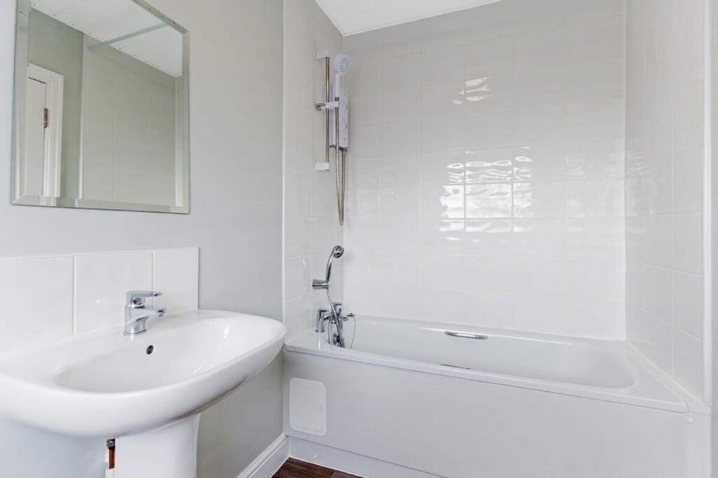 A modern bathroom featuring a sleek bathtub and...