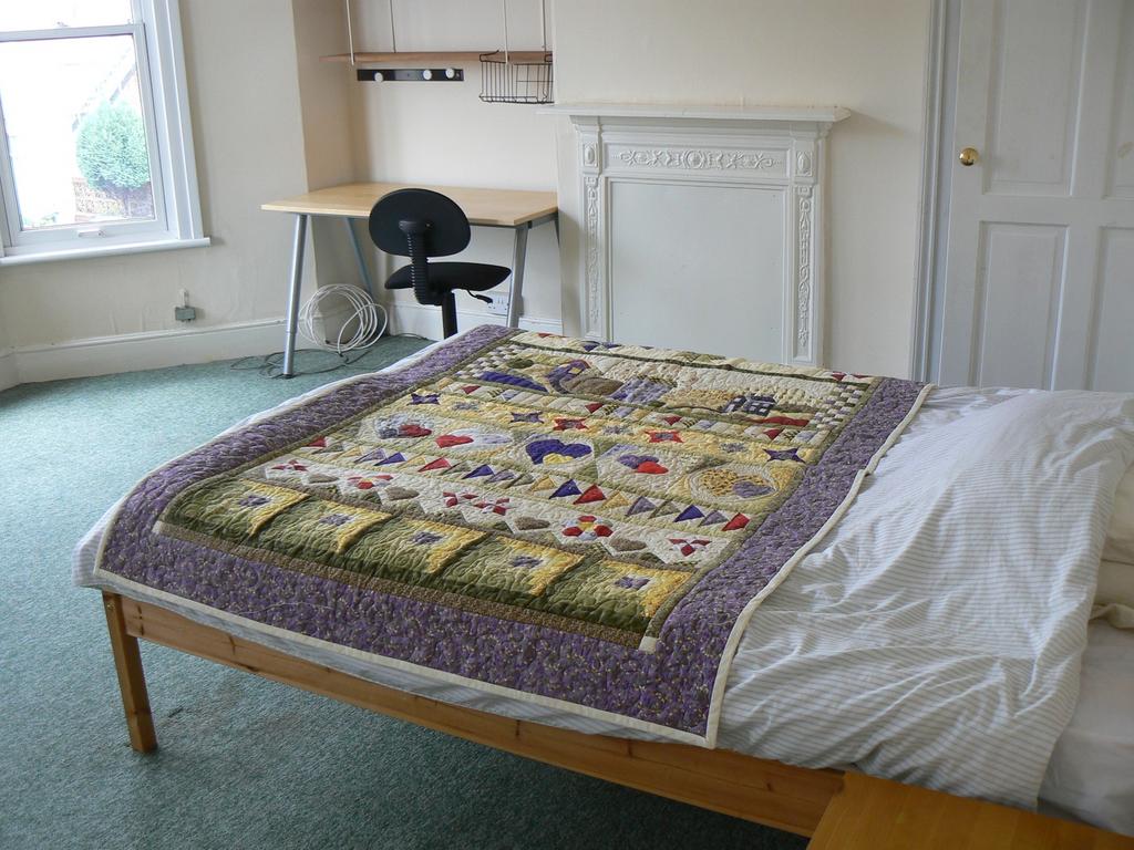 A charming double bedroom featuring a cozy bed ...