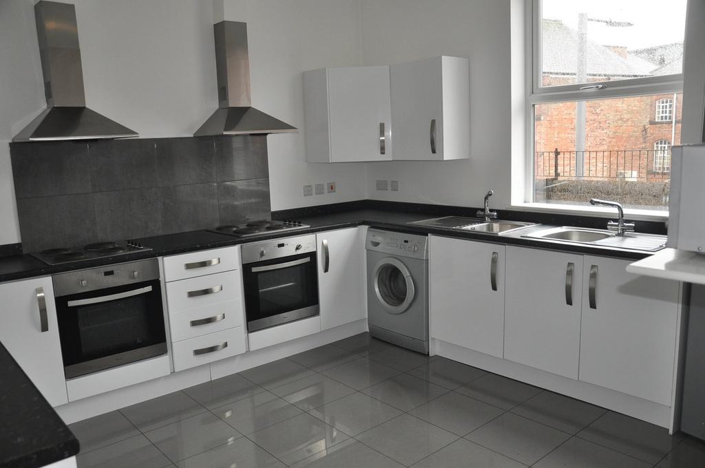 A modern and spacious kitchen with ample natura...