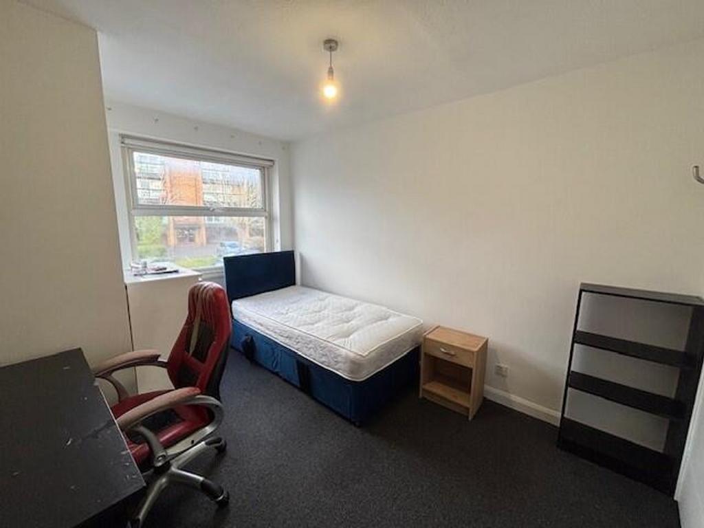 Spacious double bedroom featuring a comfortable...