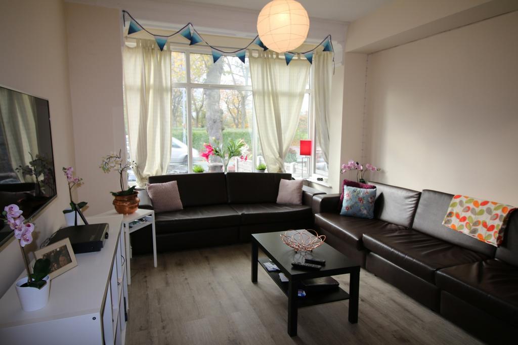 Spacious and inviting living room featuring lar...