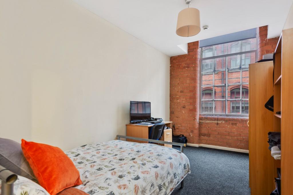 A stylish double bedroom featuring a cozy bed w...