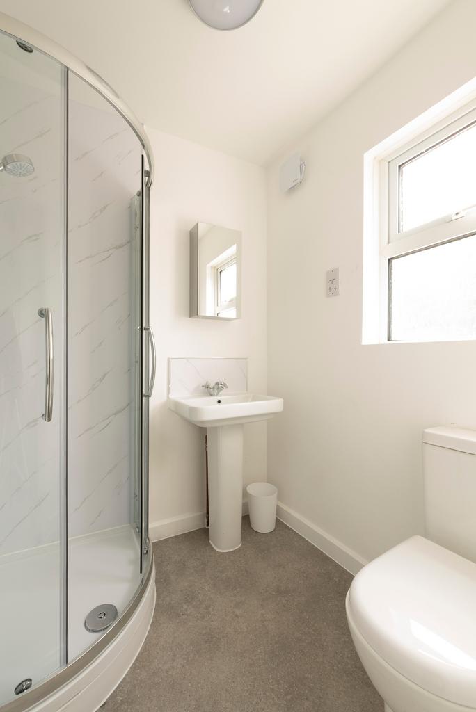 A modern bathroom featuring a sleek shower area...