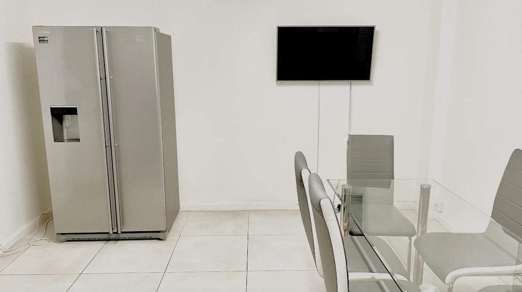 A modern kitchen featuring a sleek silver refri...