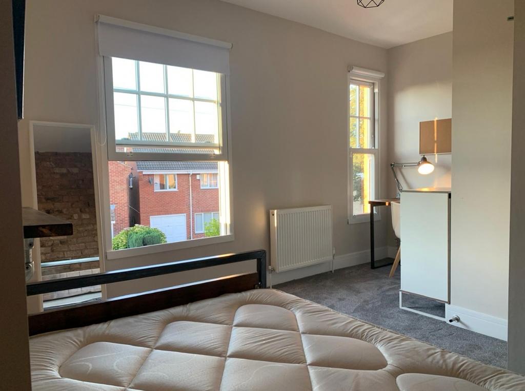 This charming double bedroom features ample nat...