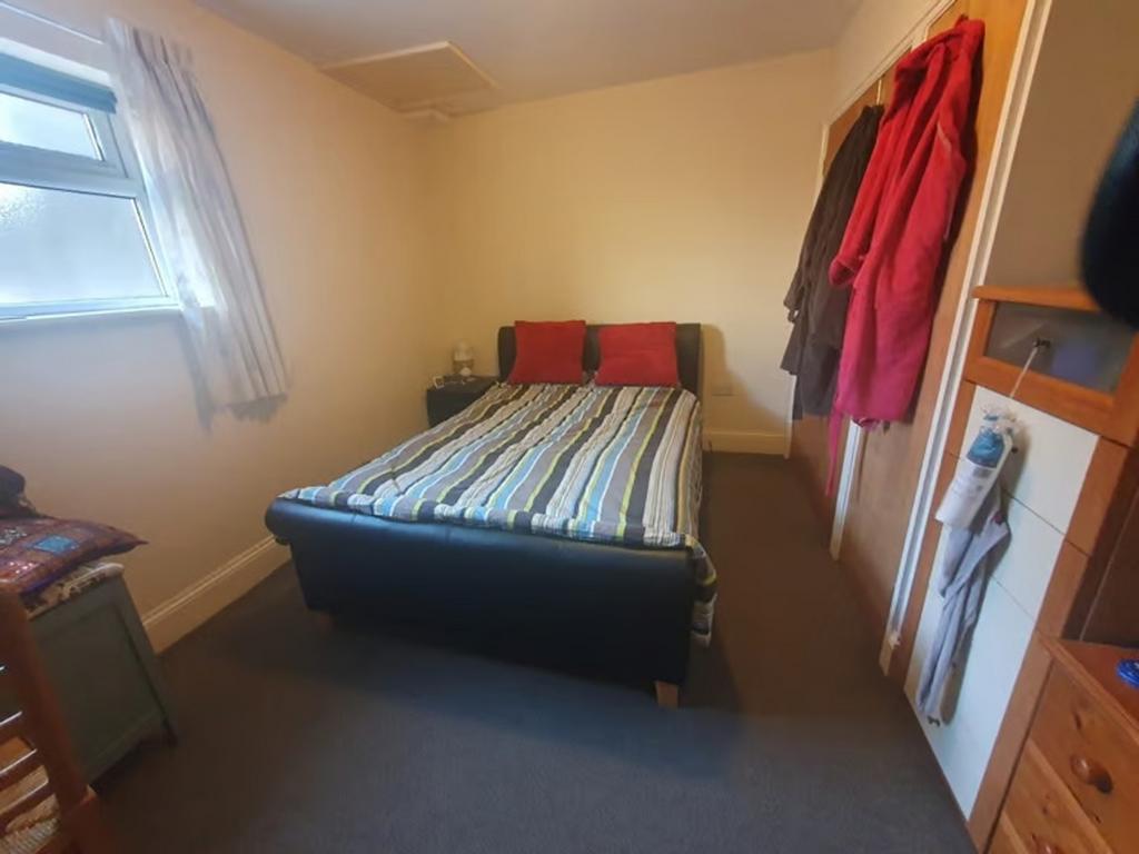 Cozy double bedroom featuring a comfortable bed...
