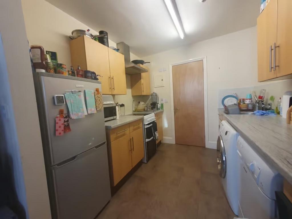 A well-equipped kitchen featuring ample cabinet...