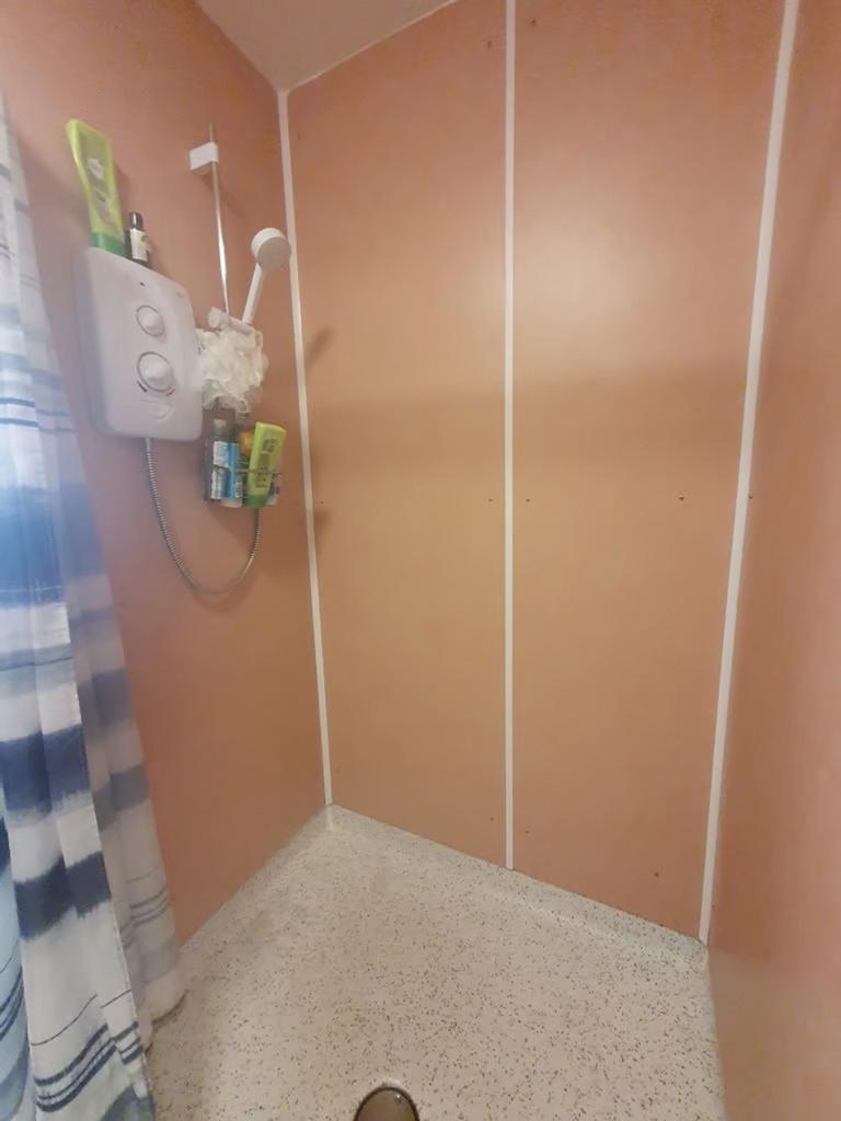 A well-maintained bathroom featuring a spacious...