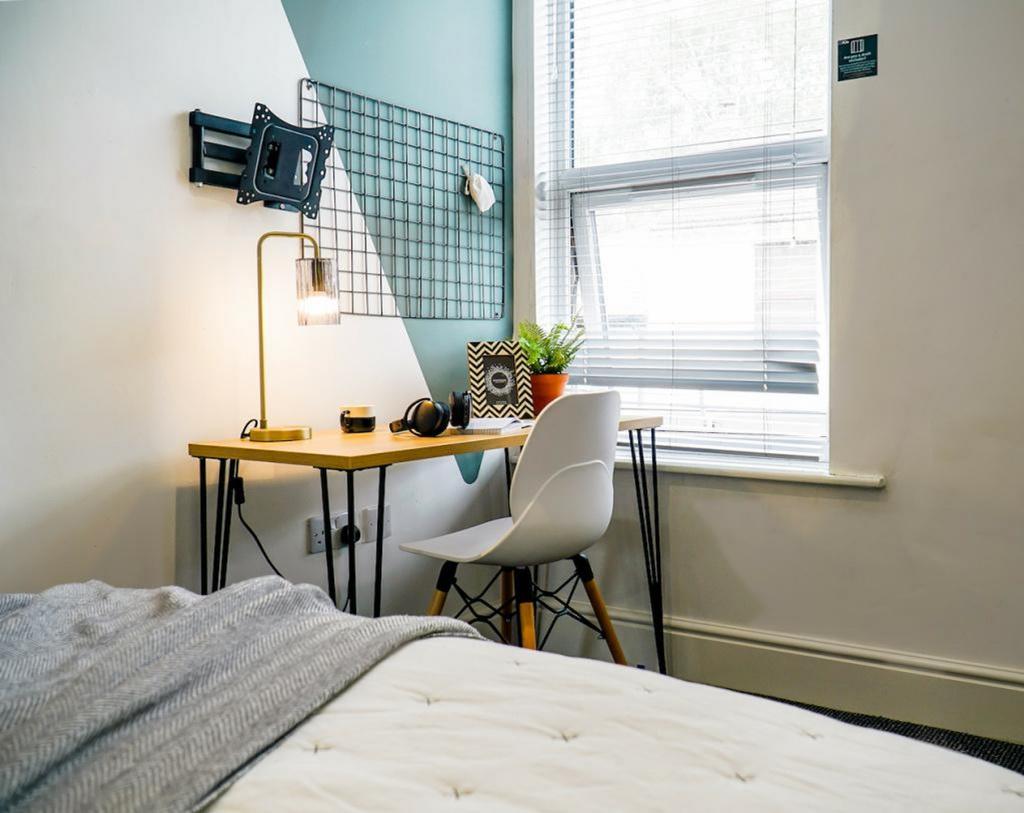 A bright and stylish double bedroom featuring a...