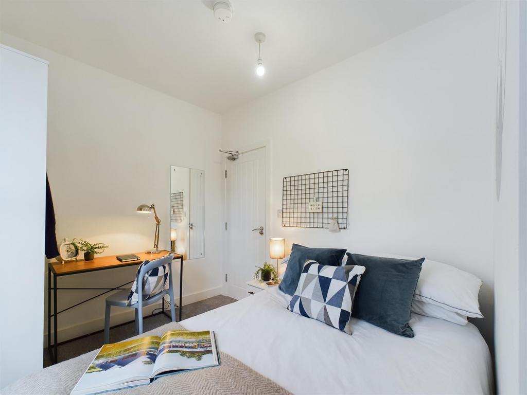 Bright and welcoming double bedroom featuring a...