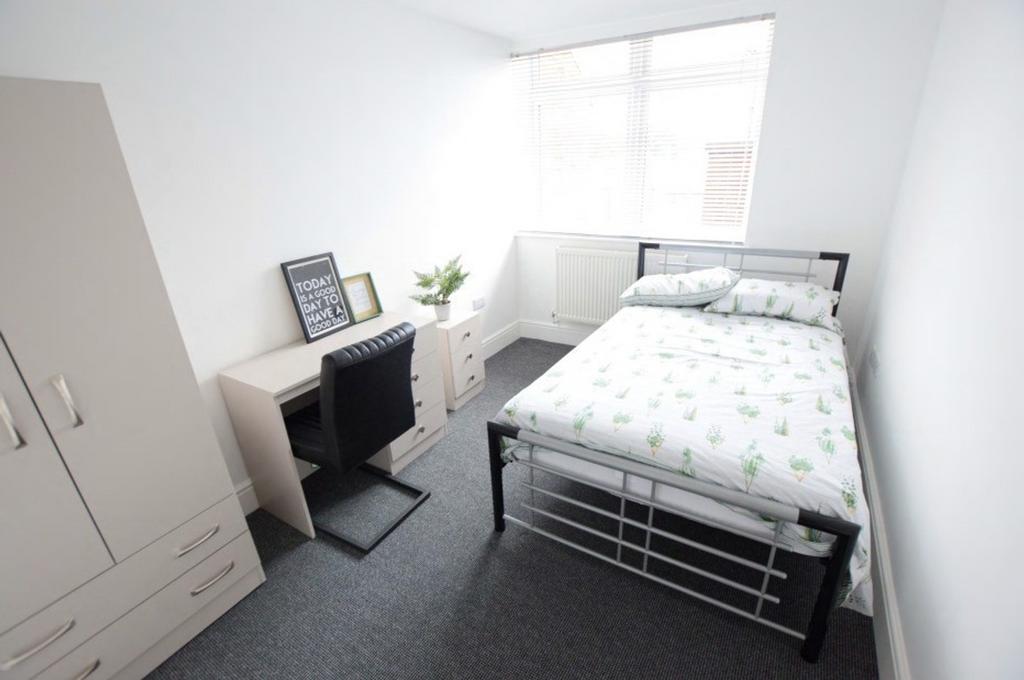 A bright and tidy double bedroom featuring a co...