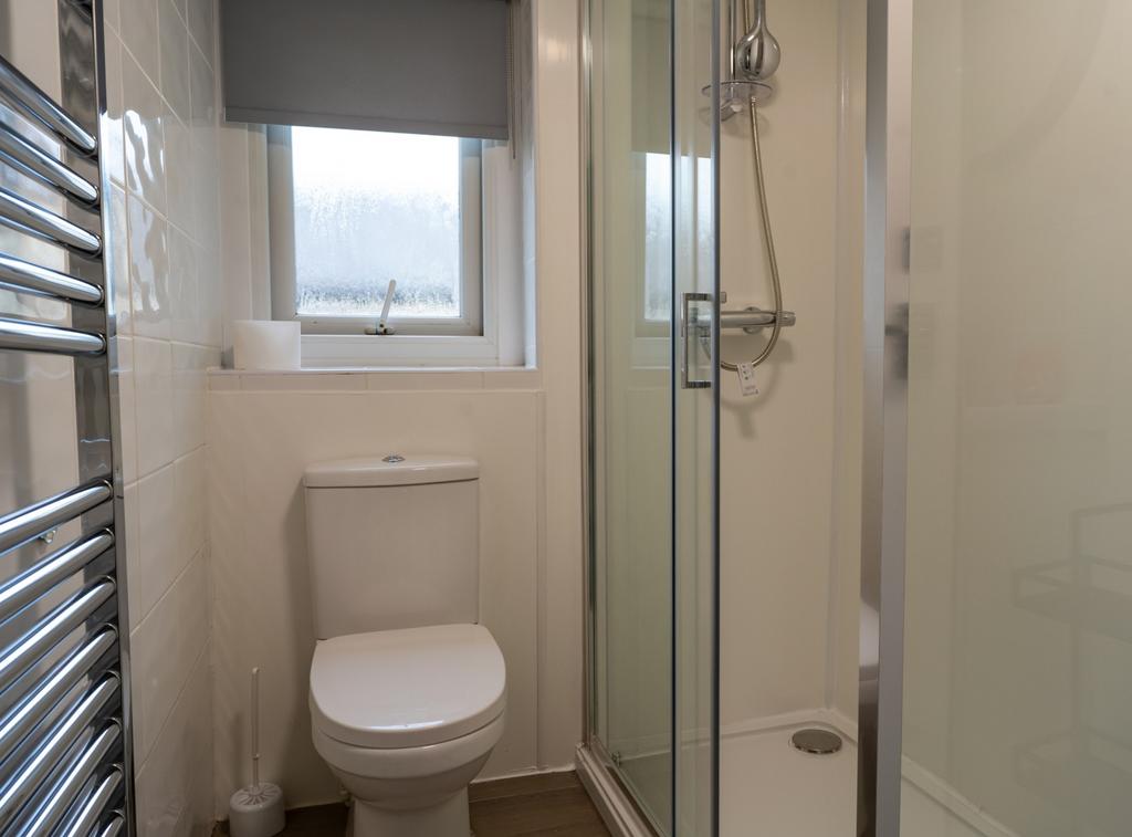 A modern and tidy bathroom featuring a sleek sh...
