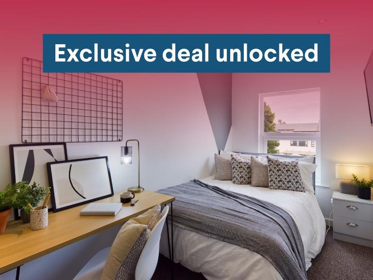 Bright, neatly styled double bedroom with a com...