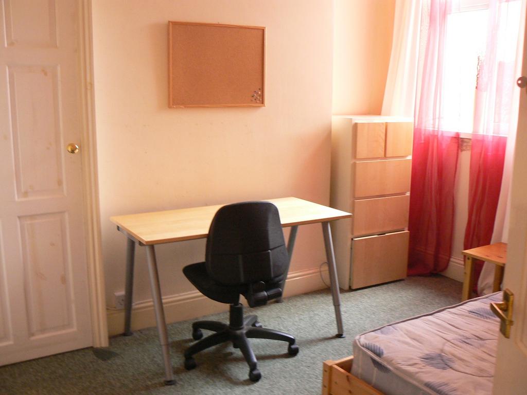This cozy double bedroom features a comfortable...