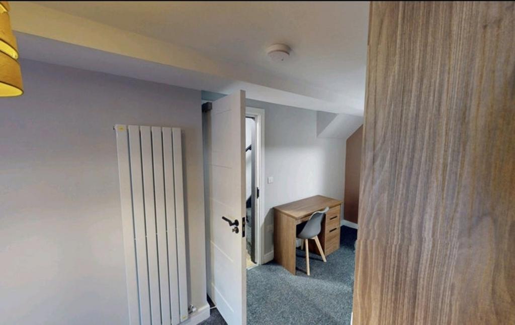 This inviting double bedroom features a cozy de...
