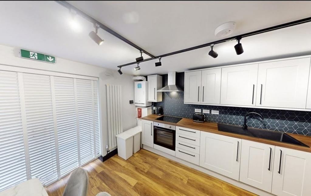A modern kitchen featuring sleek cabinetry, a s...
